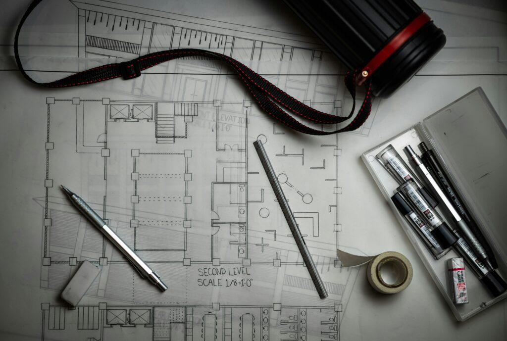 Cost to build a house 2026 [describe what is visible, e.g. architectural blueprints, construction site, framing stage]