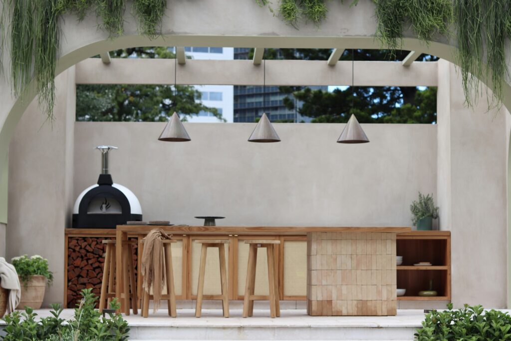 Outdoor kitchen and pool cost 2026 modern luxury outdoor kitchen with bar seating pizza oven and premium appliances
